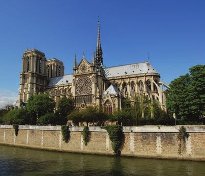 A photograph of the Notre Dame Cathedral taken from the side view, probably from a boat in the middle of river